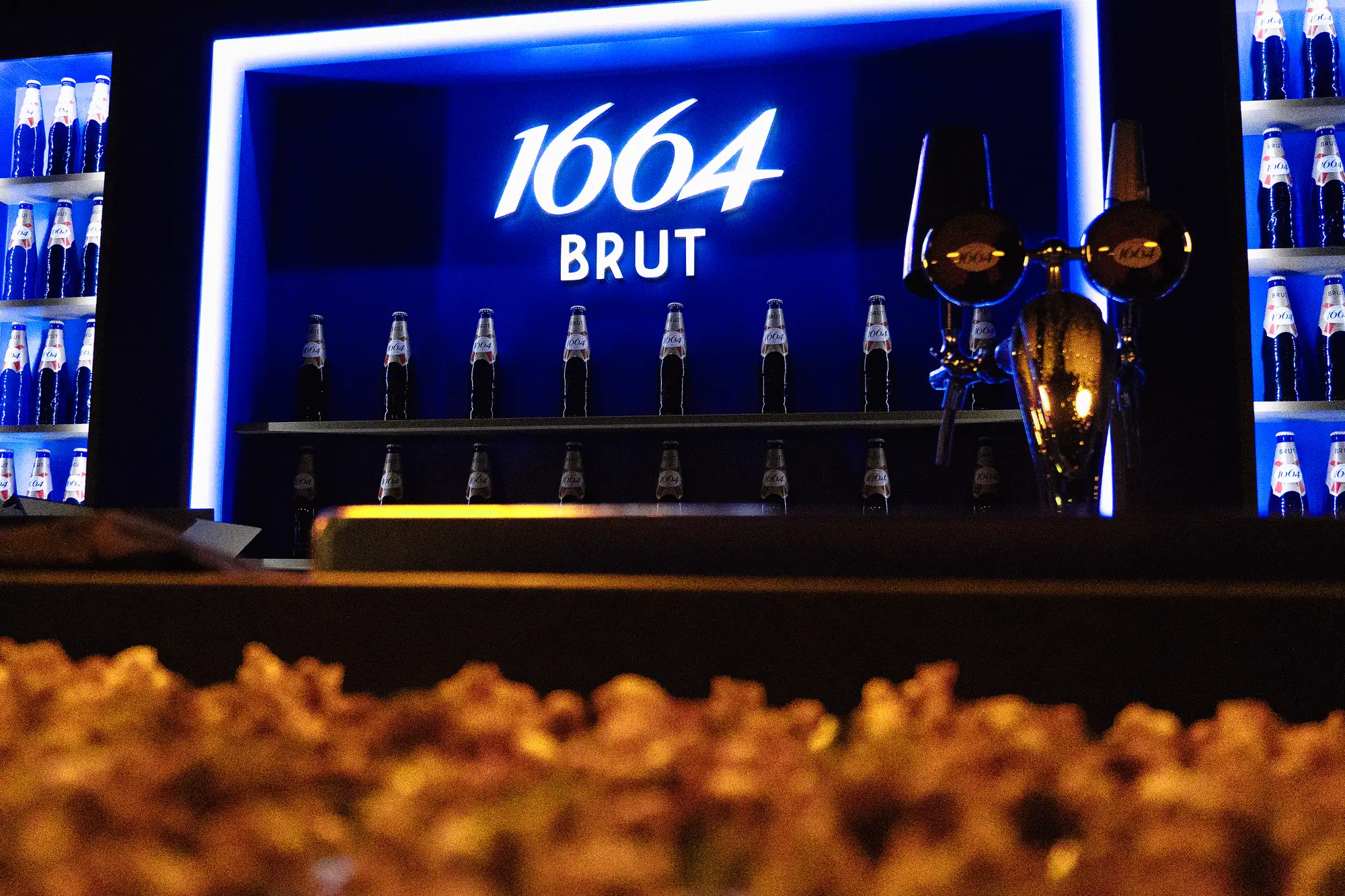 The back bar with the 1664 Brut sign, bottle shelves and taps