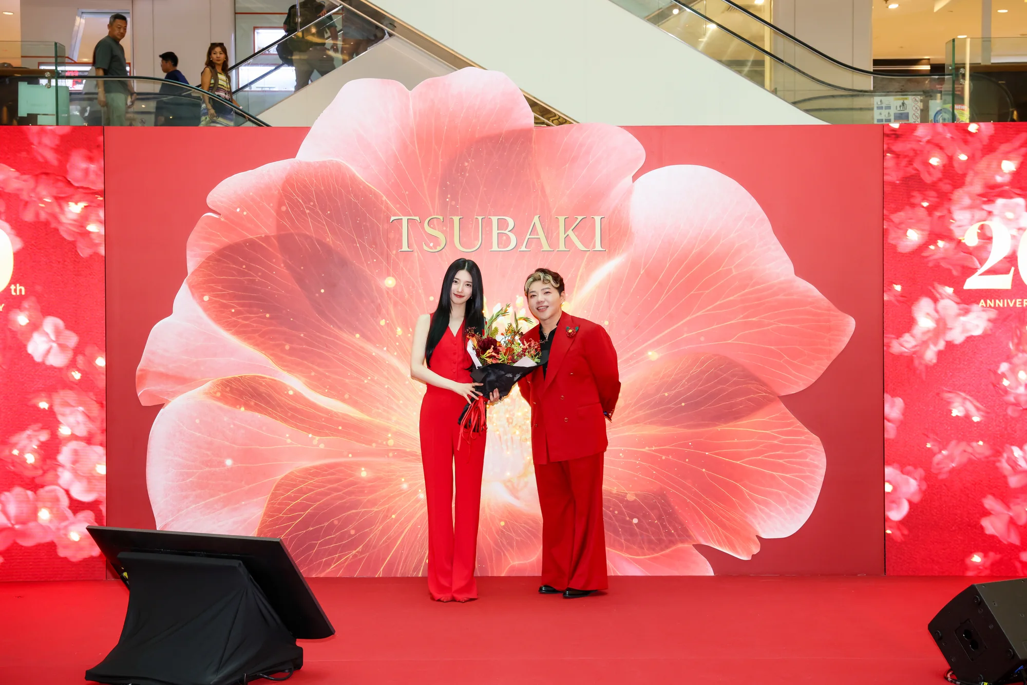 Suzy Bae on the roadshow stage in front of the giant camellia backdrop