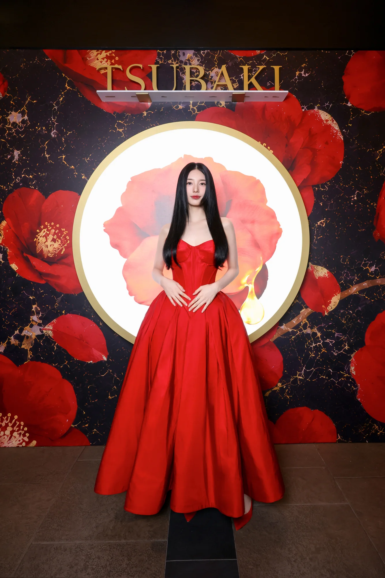 Suzy Bae at the photo wall framed by a camellia ring