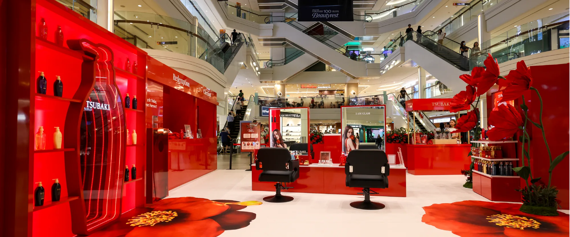 The finished roadshow in the mall atrium, with the infinity bottle, styling chairs and giant flowers