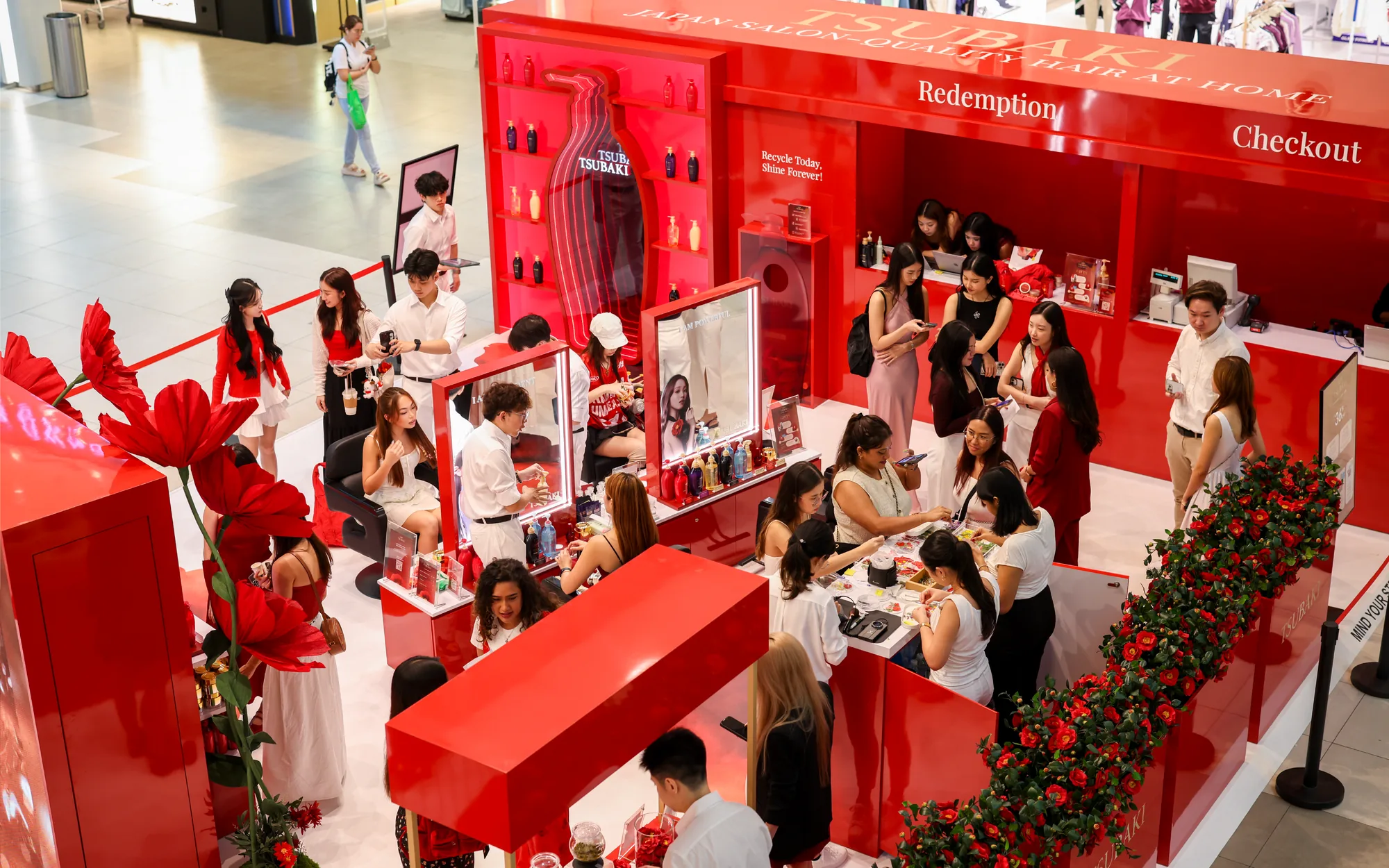 Guests at the styling mirrors and at the redemption and checkout counters, seen from above